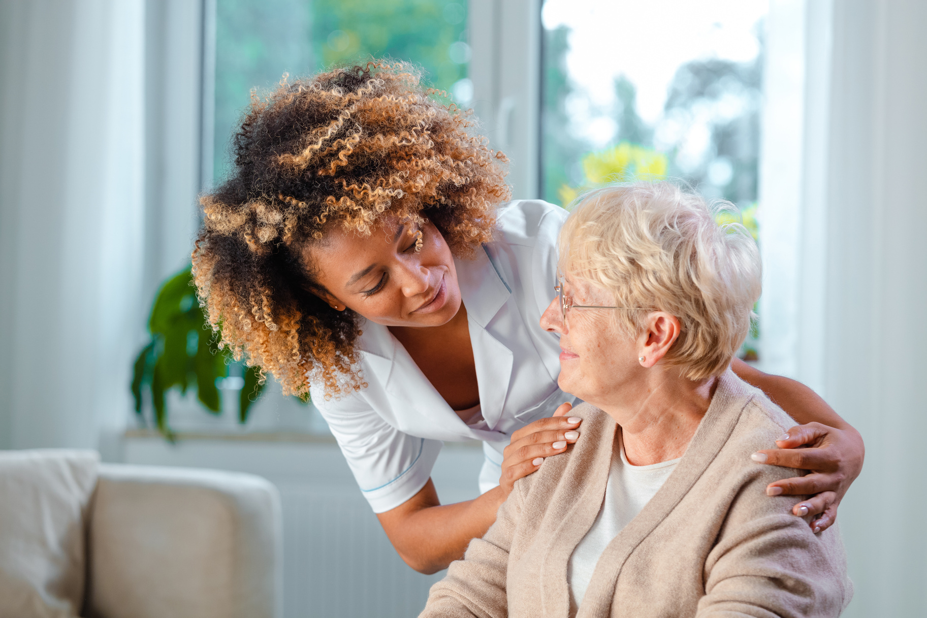 Home nurse taking care of a senior woman