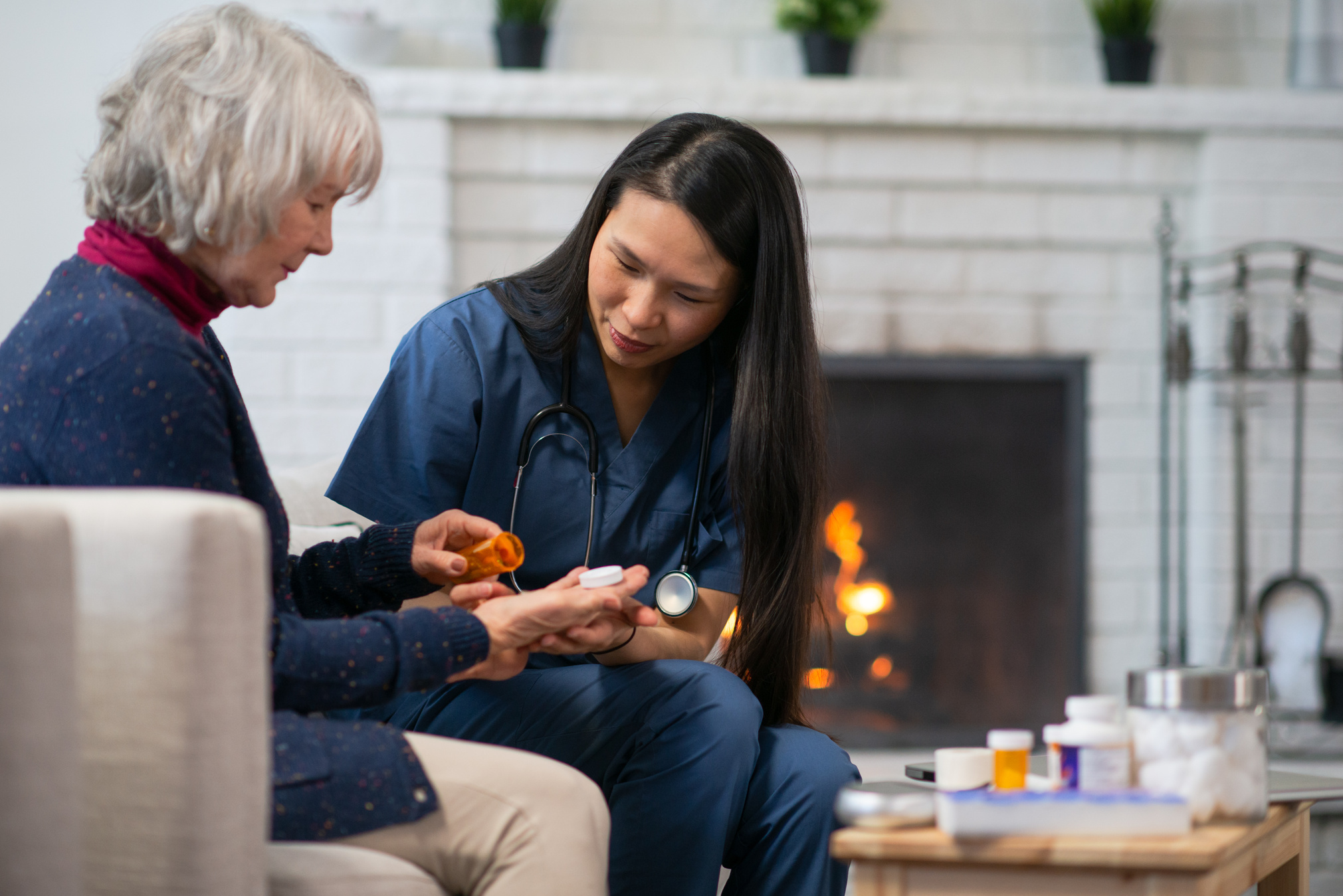 Home Care Nurse Visits Elderly Woman stock photo